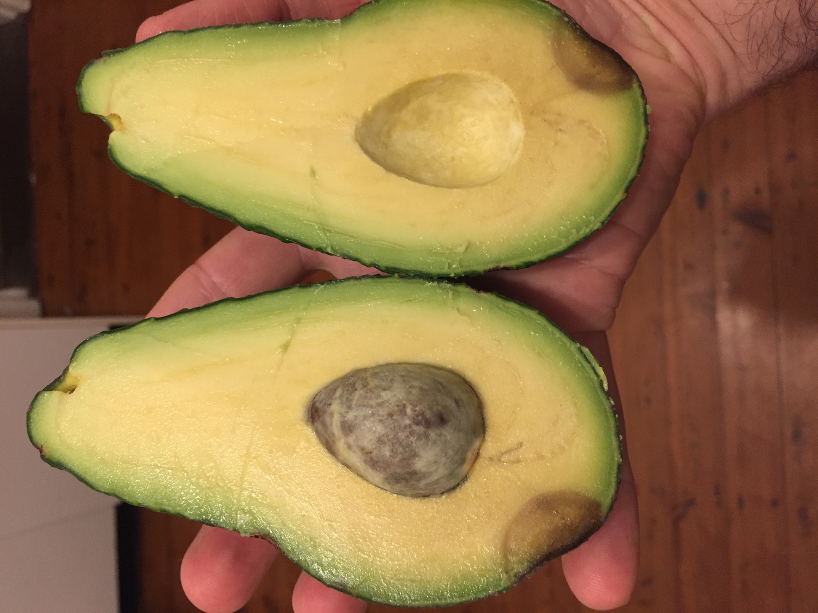 Pinkerton avocado cut open with one little brown spot near the bottom. Quite a small seed given the size of the fruit. Nice flavour.