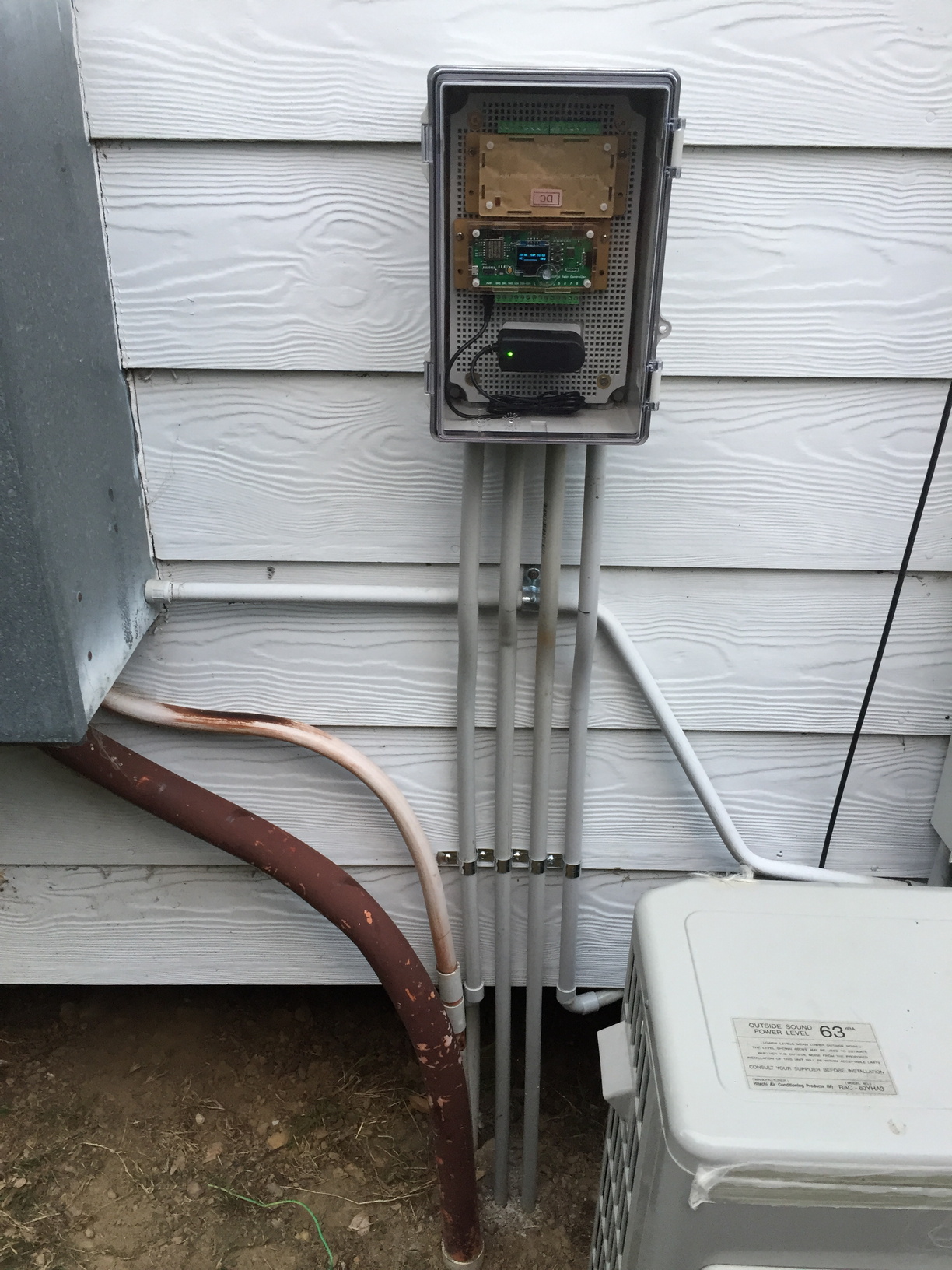 The final product, all wired in and closed up. Huge thanks to my father-in-law for doing such a neat job with the electrical conduit, even using a flame-torch to heat and bend the conduit so it sits neatly over the conduit going to the air-conditioner.