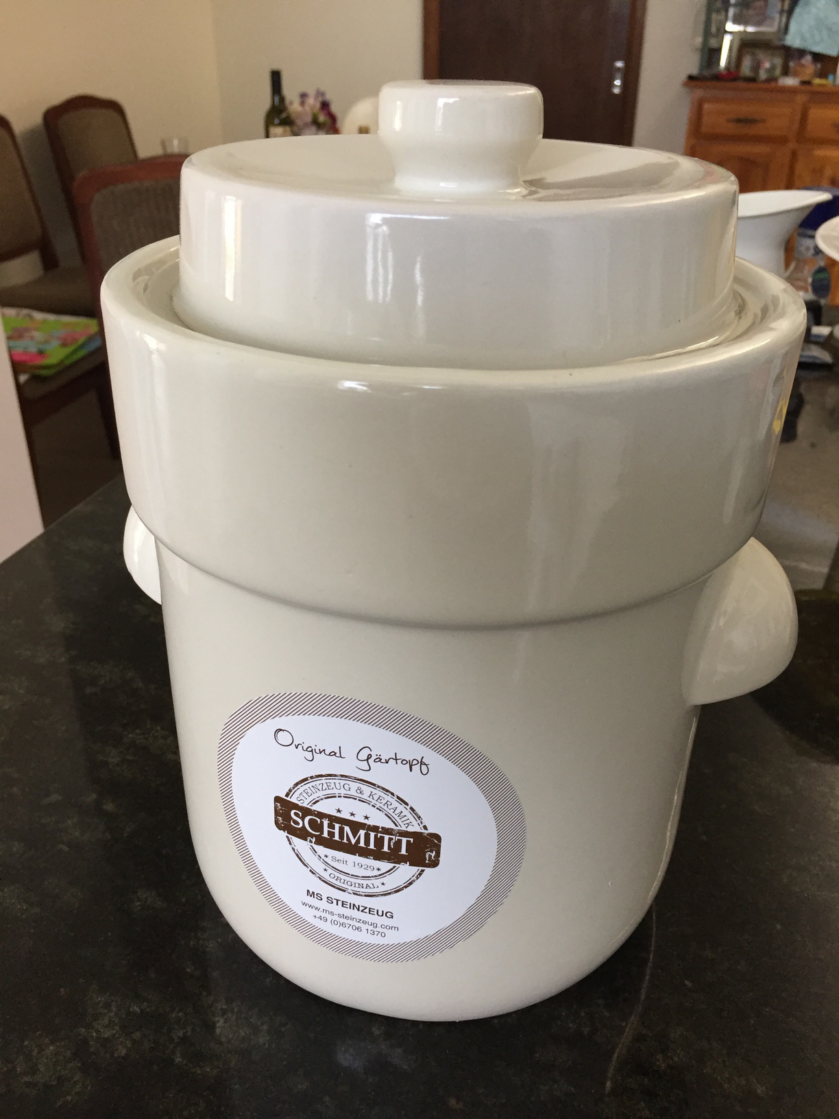 Fermenting crock with the lid on and the water seal filled around the lid