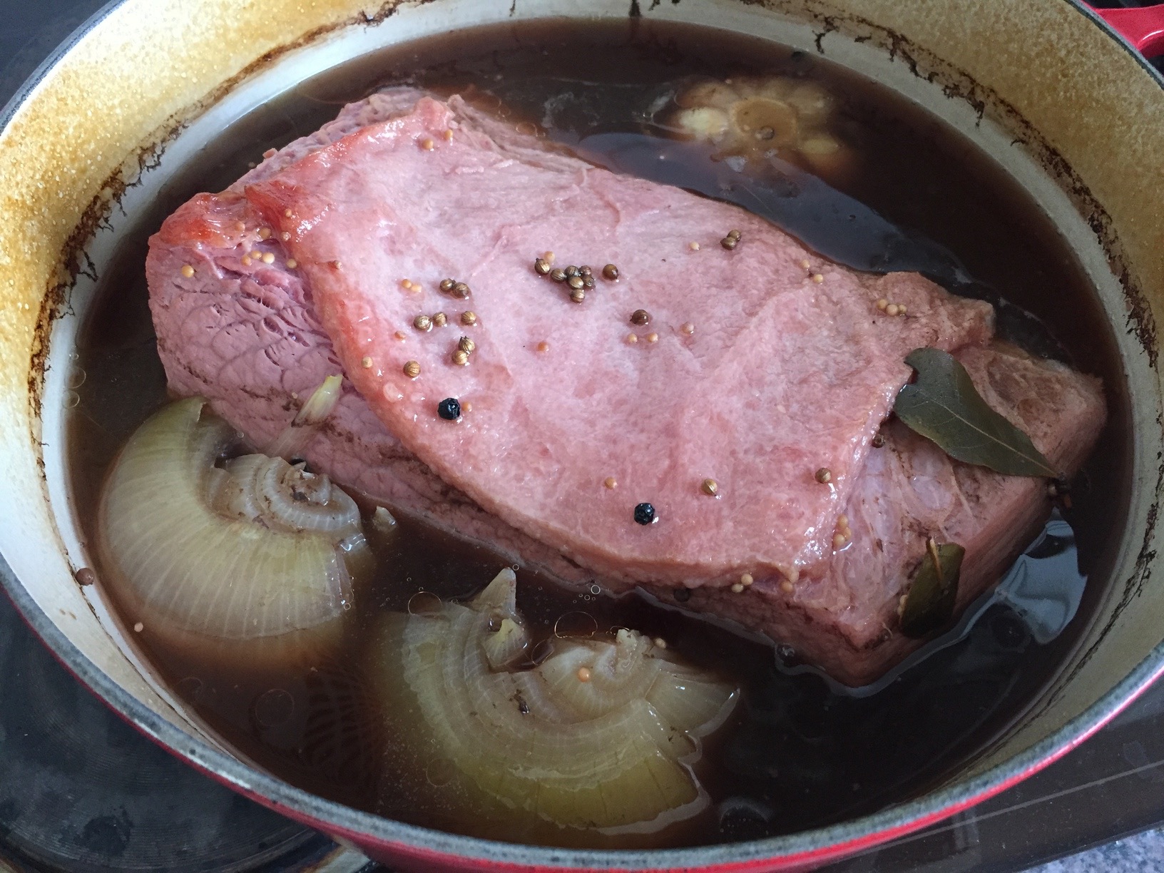 Corned beef cooked in Guinness, with spices, onions and a head of garlic