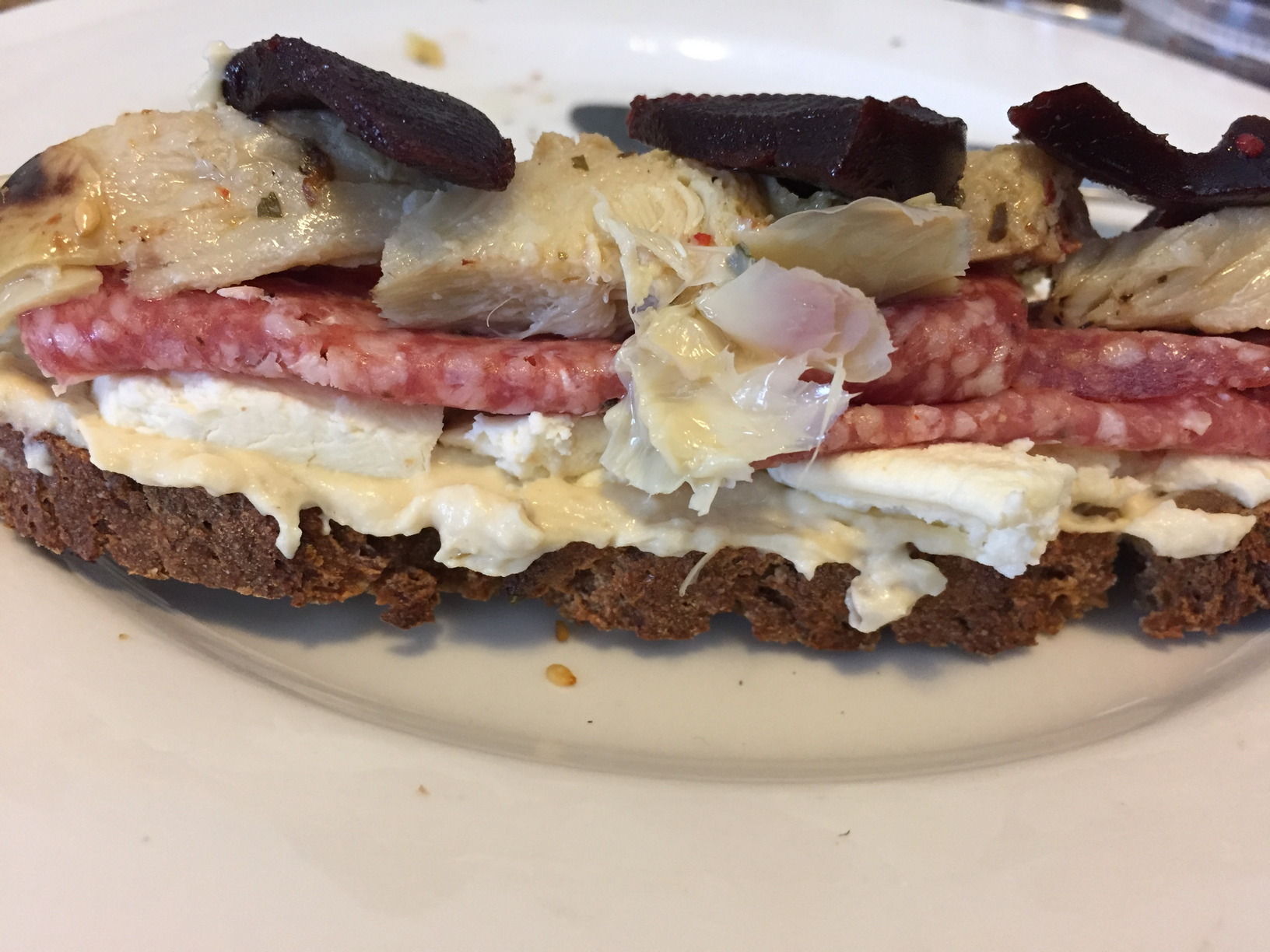 This was an assembled slice of bread, prior to being devoured. Salami, soft cheeses, artichoke hearts and quince paste